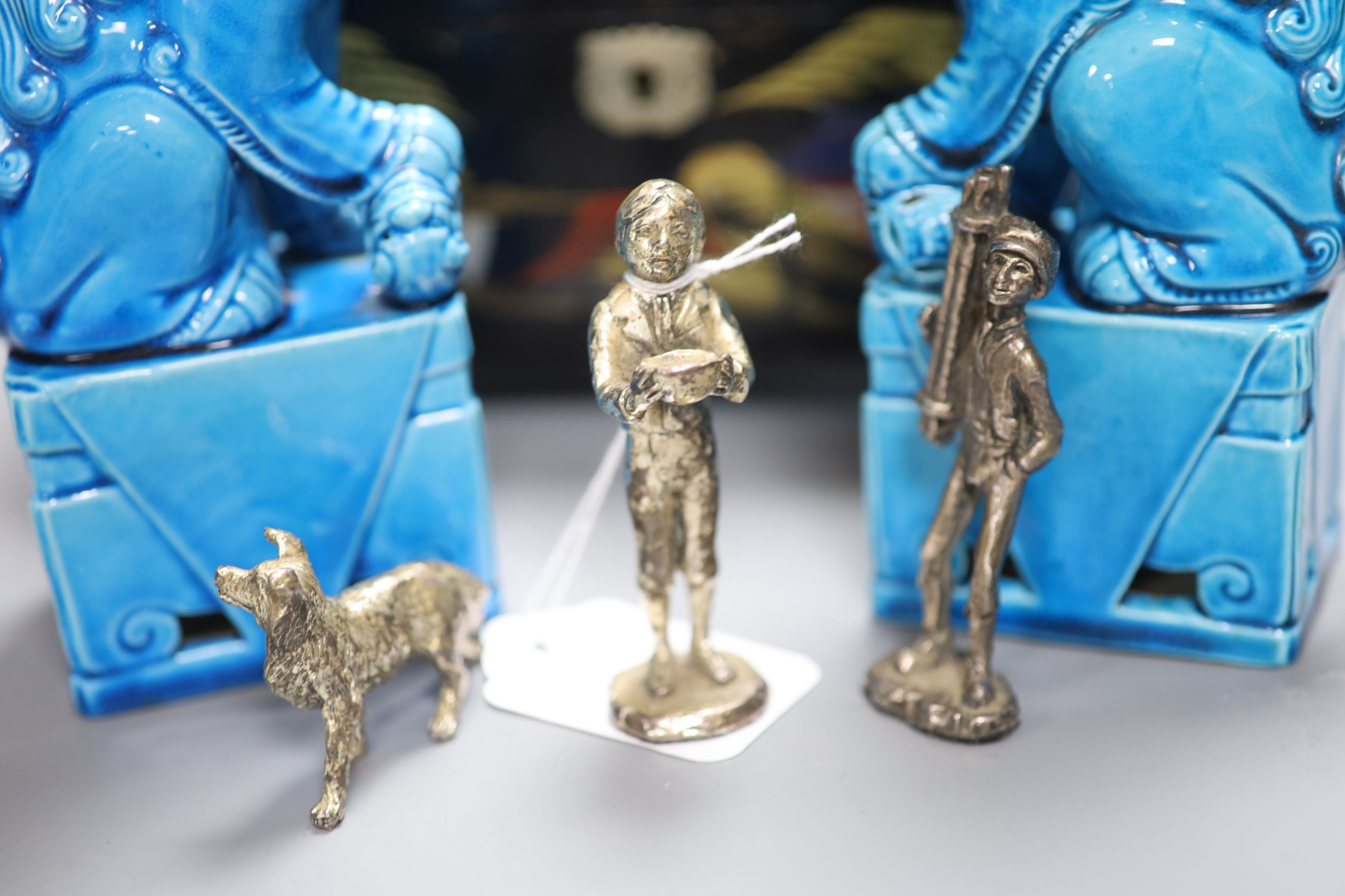 A pair of Chinese turquoise-glazed lion dogs, a lacquered jewellery box and three plated miniature figures